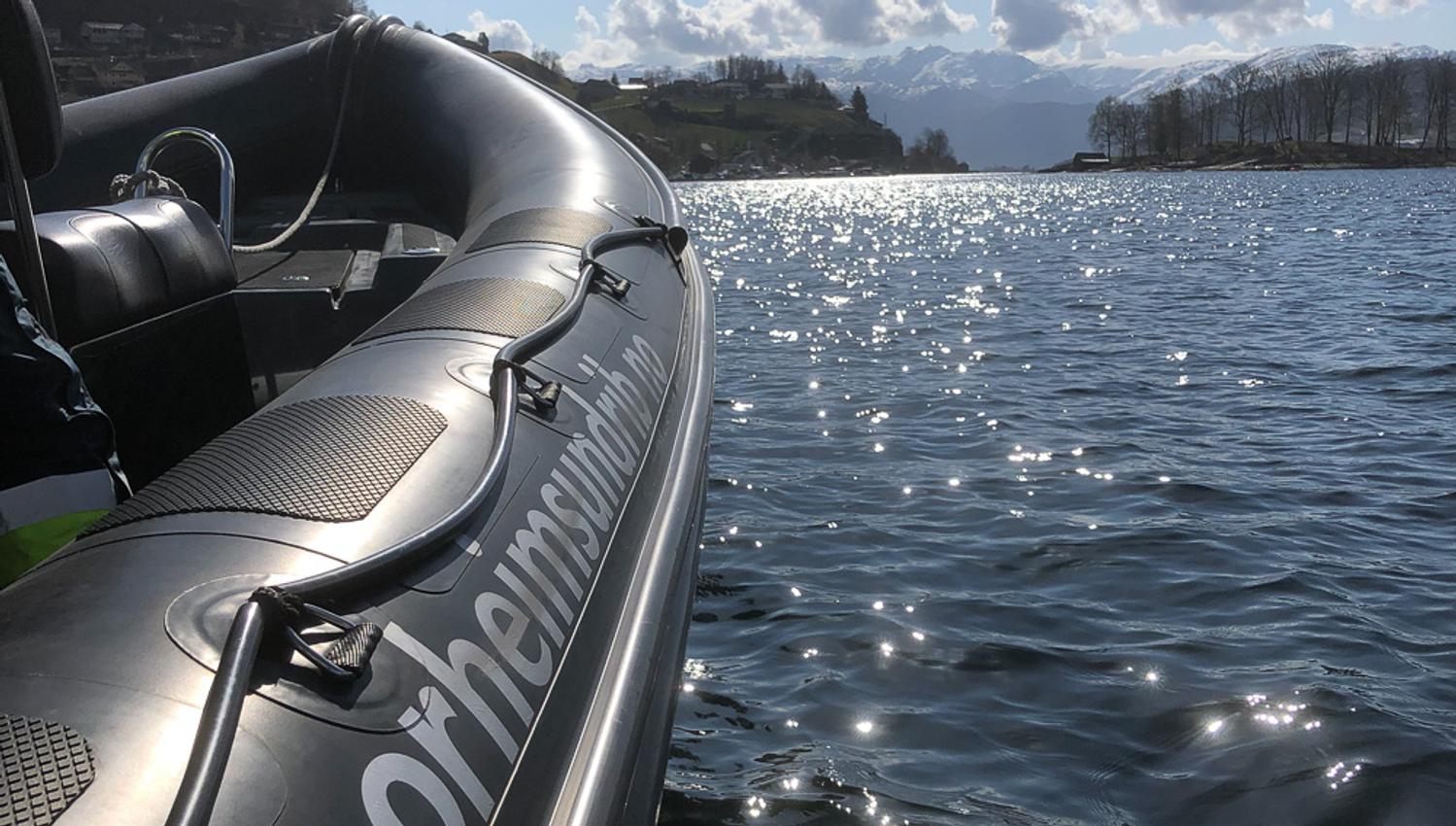 Sunlit fjord scenery reflecting in a RIB boat from Norheimsund RIB Seafari.