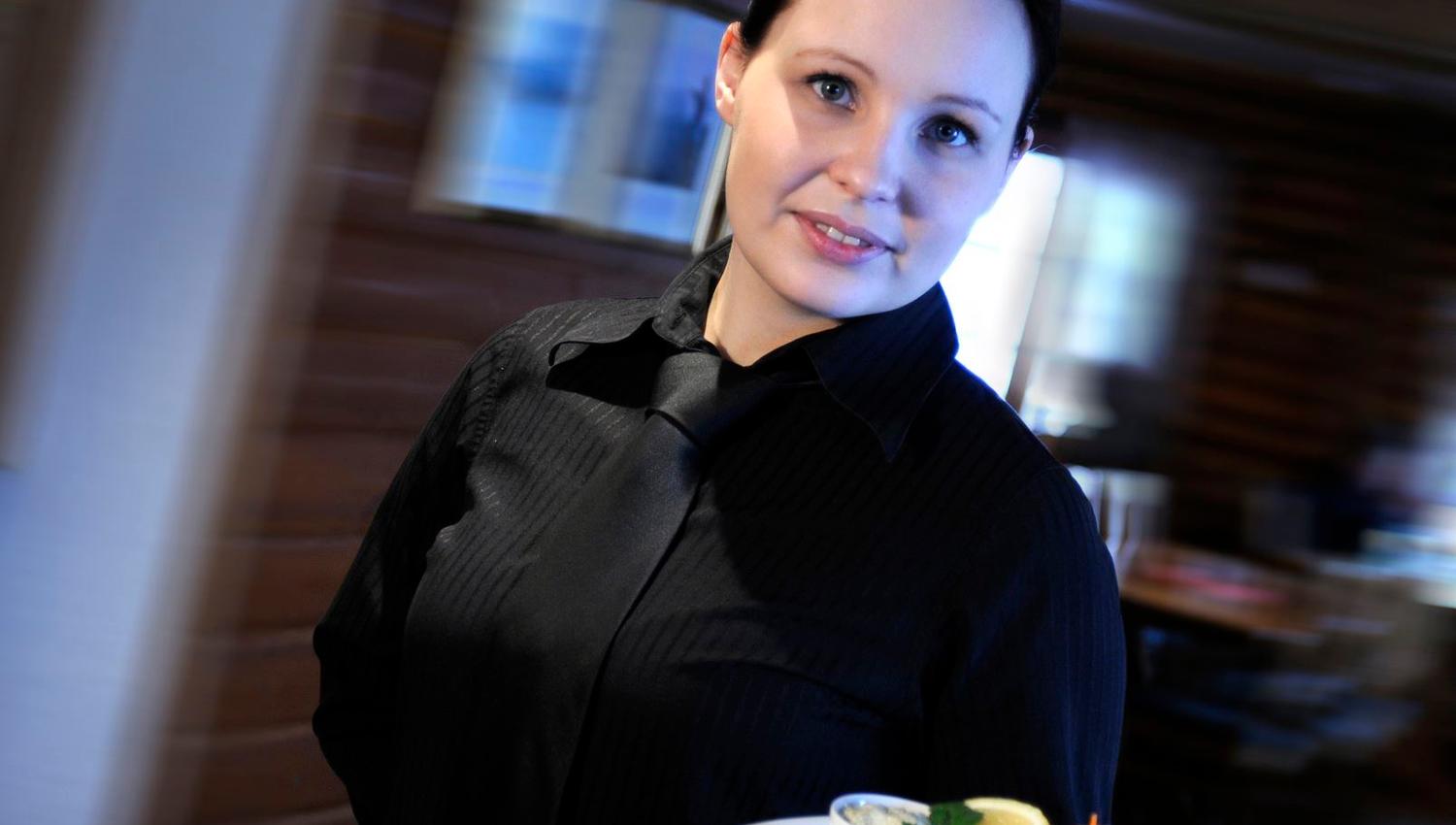 Waiter in black shirt and tie