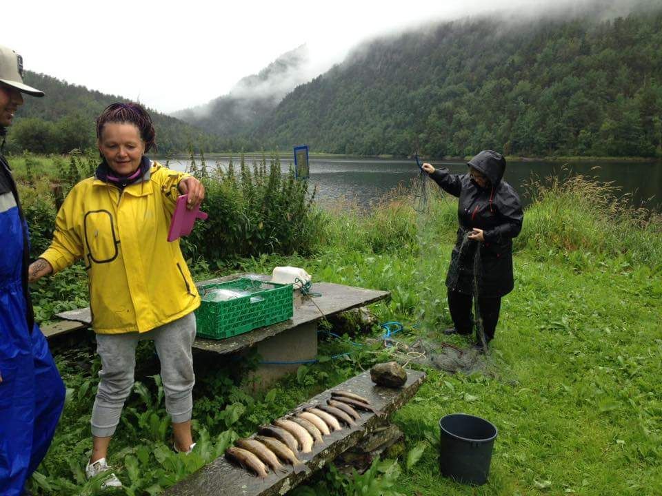 Guests enjoying fishing by the lake near Folgefonn Farm Camping – a true Hardanger experience.