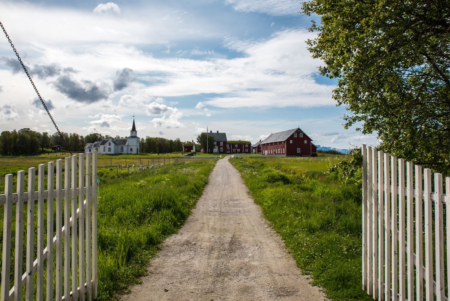 Gravel road leading to a traditional church.