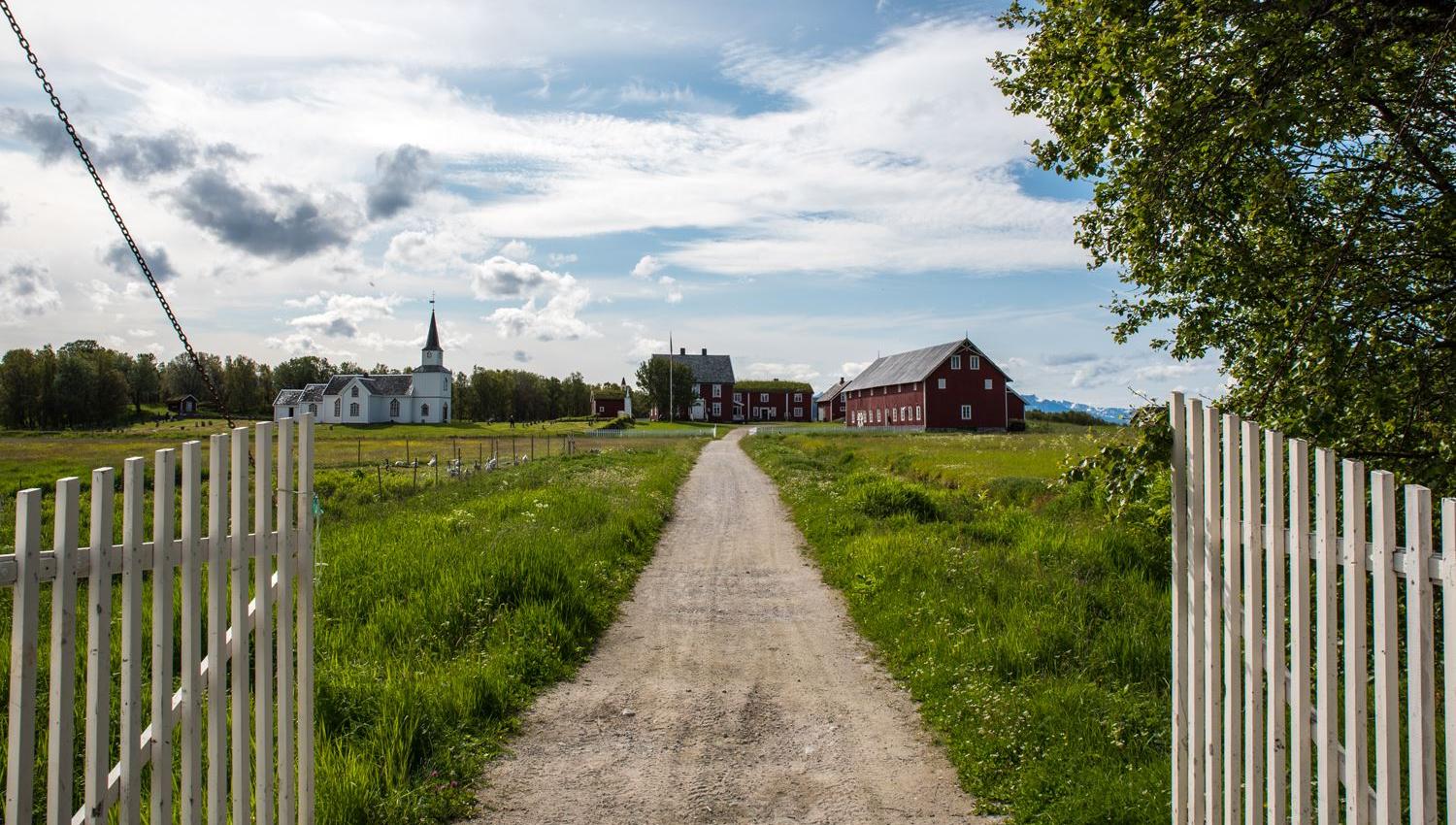 Gravel road leading to a traditional church.