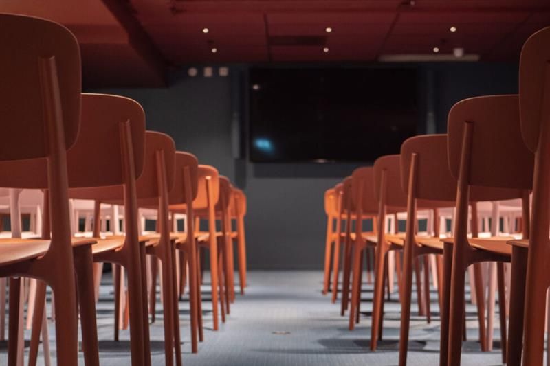Auditorium with a TV screen on the wall.