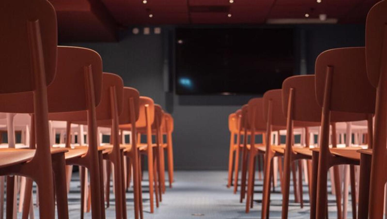 Auditorium with a TV screen on the wall.