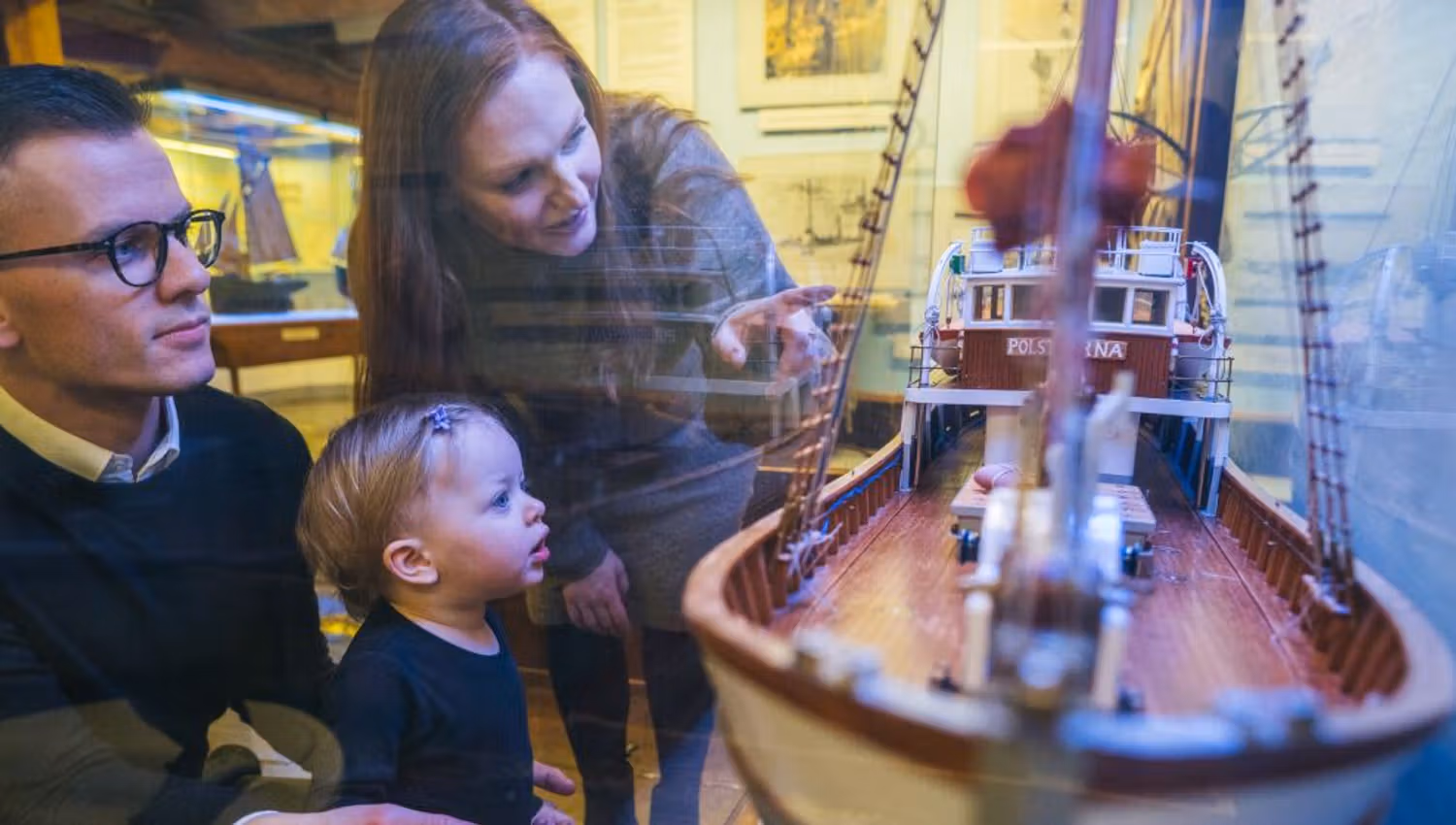 Family studying the exhibition at the Polar Museum in Tromso
