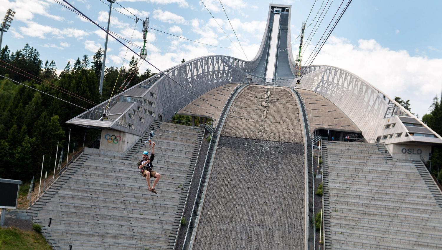 Person ziplining down Holmenkollen Ski Jump.