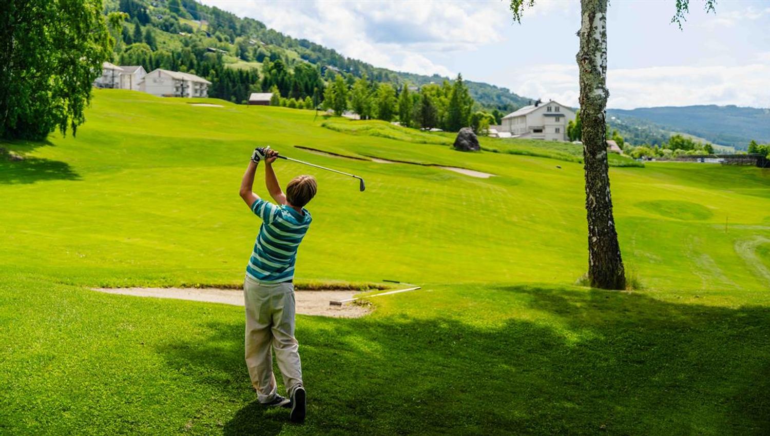 Golfer hitting a shot on the golf course.