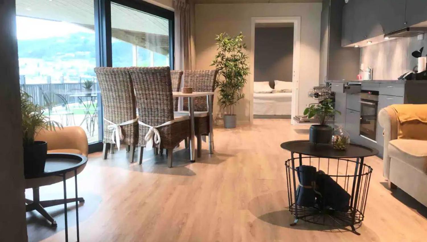 Spacious living room with natural materials and modern interior, overlooking the fjord.