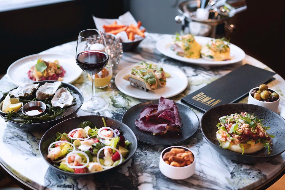 Table set with different dishes and a glass of red wine