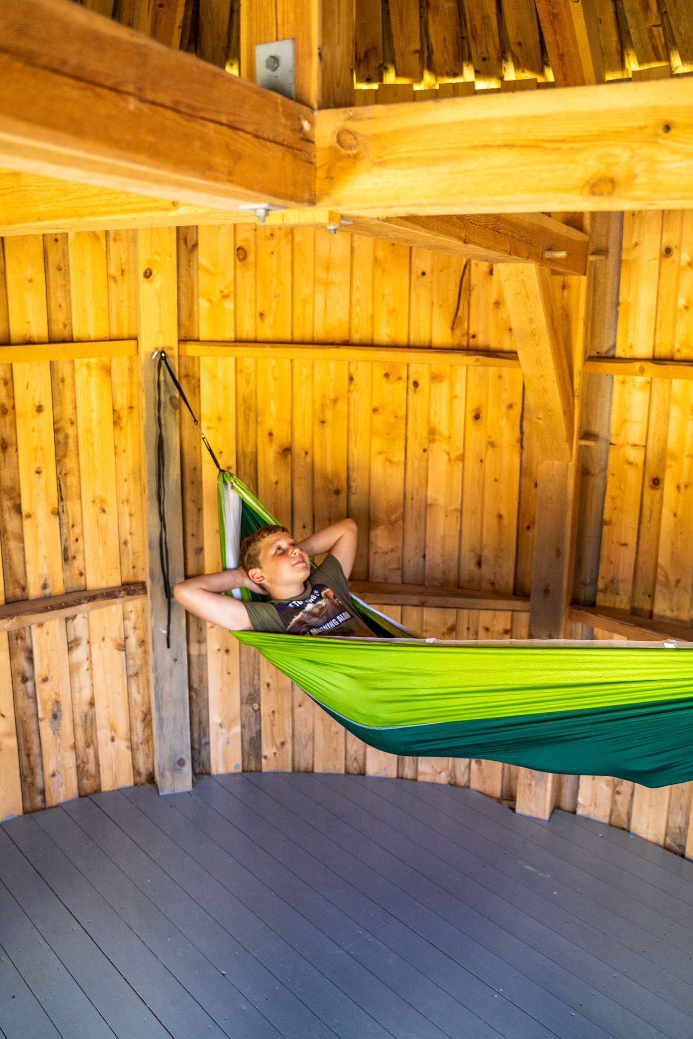 Boy in a hammock in a hut