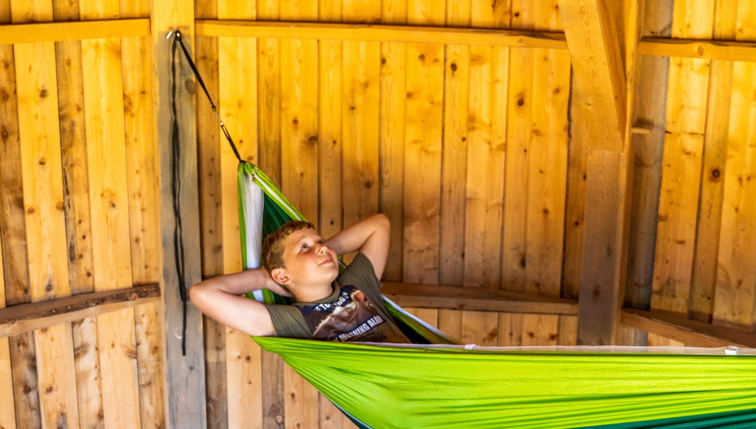 Boy in a hammock in a hut