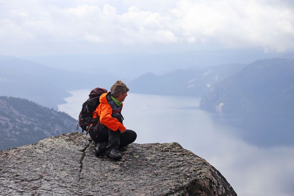 man enjoys the view from the top of Våmur, Fyresdal