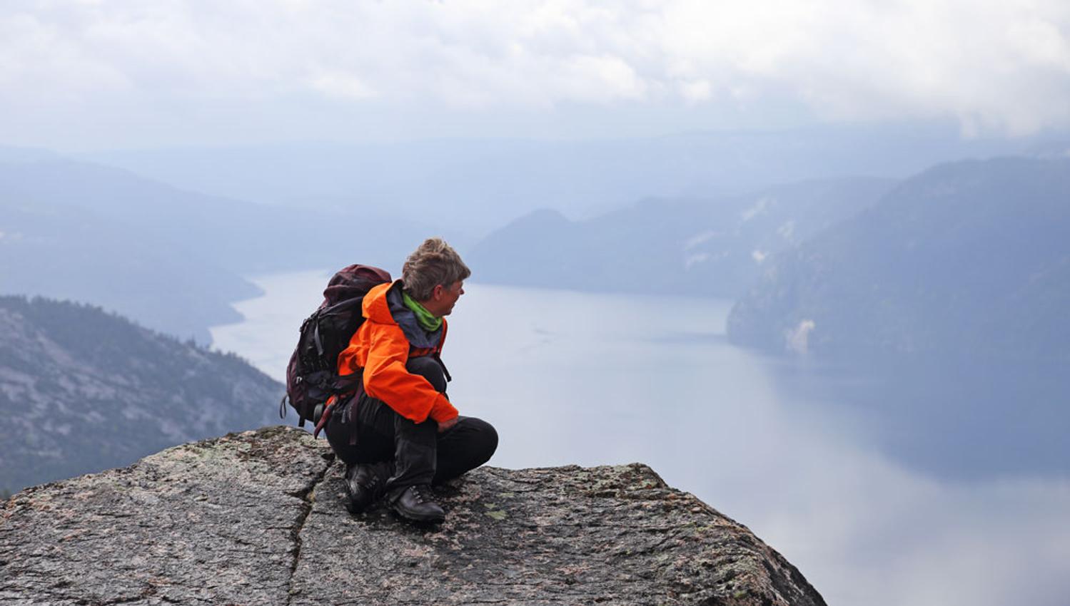 man enjoys the view from the top of Våmur, Fyresdal