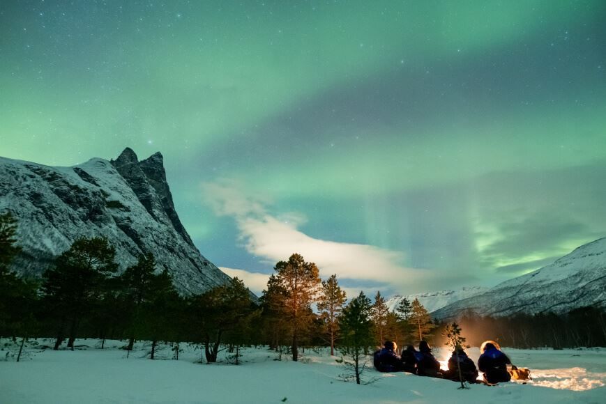 Campfire under northern lights