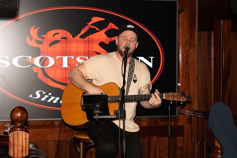 Man performing with a guitar on stage