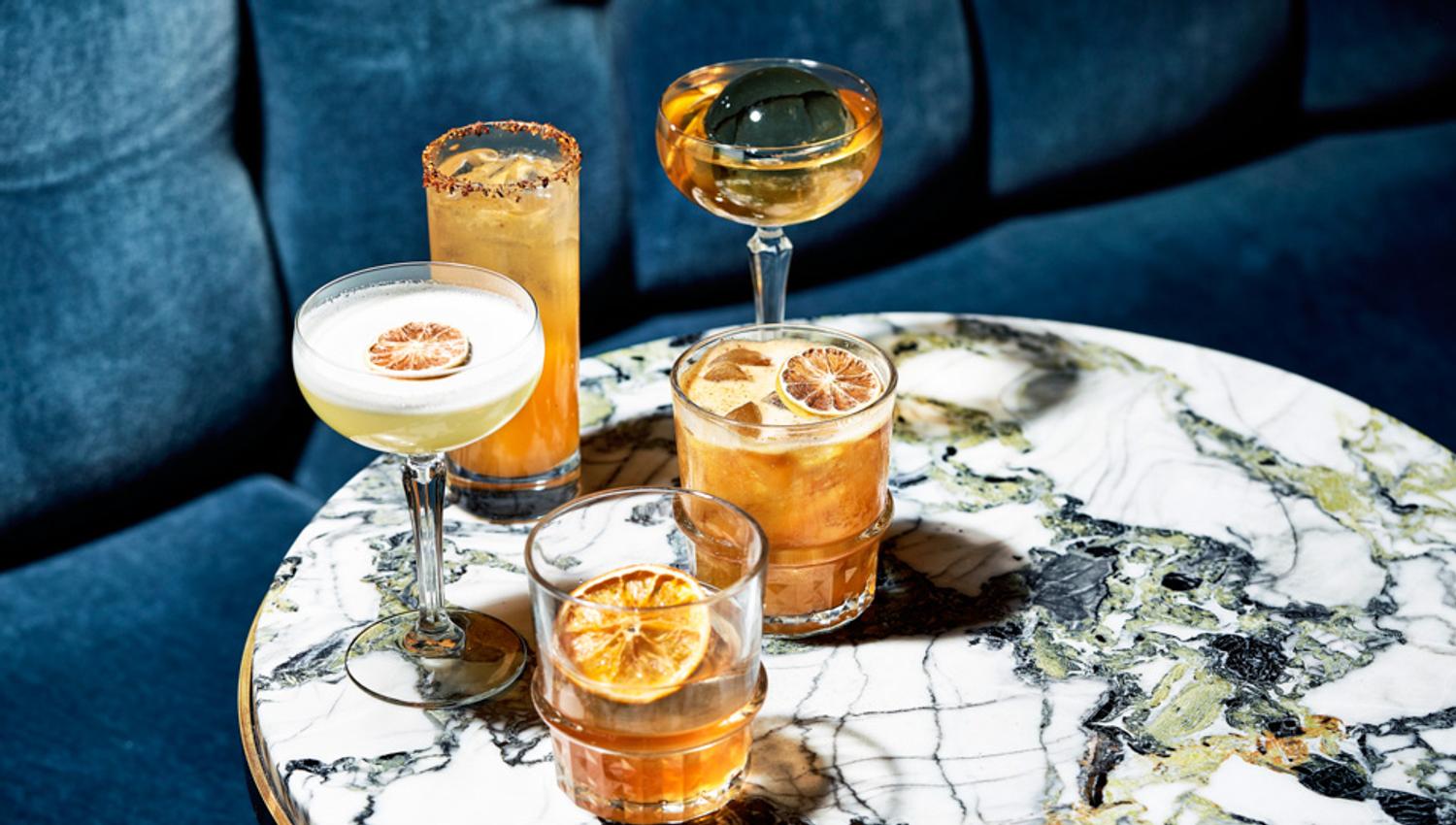 Five different drinks on a marble table