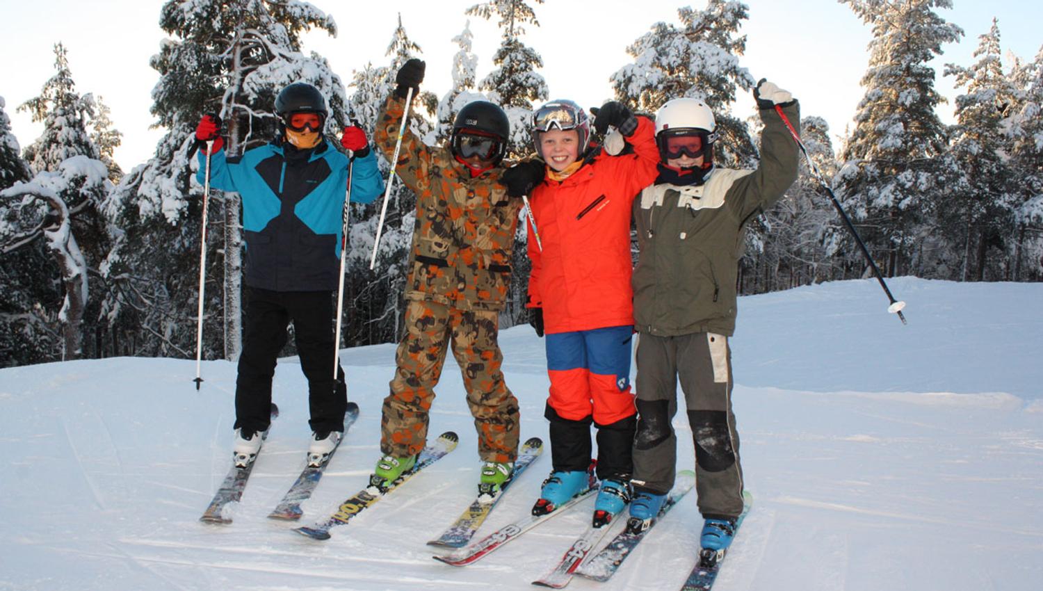a group of children in ski clothing