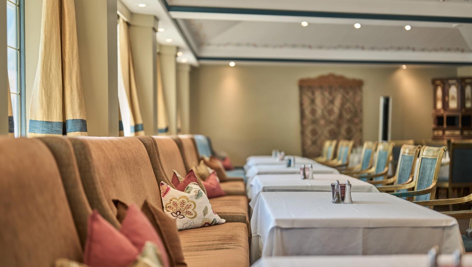 Elegant dining room with decorated chairs and pillows at Hotel Ullensvang.
