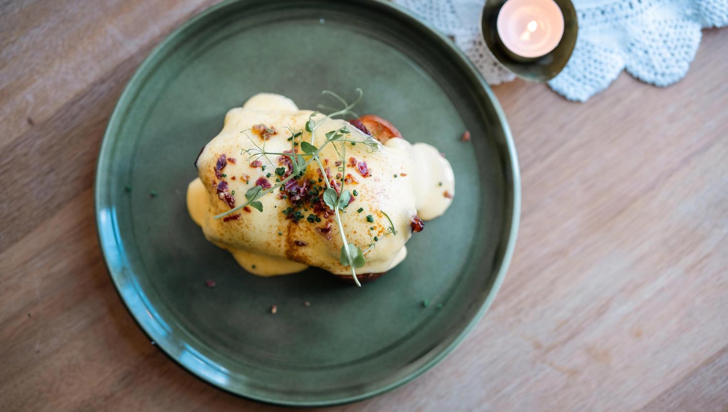 Eggs Benedict on a green plate.