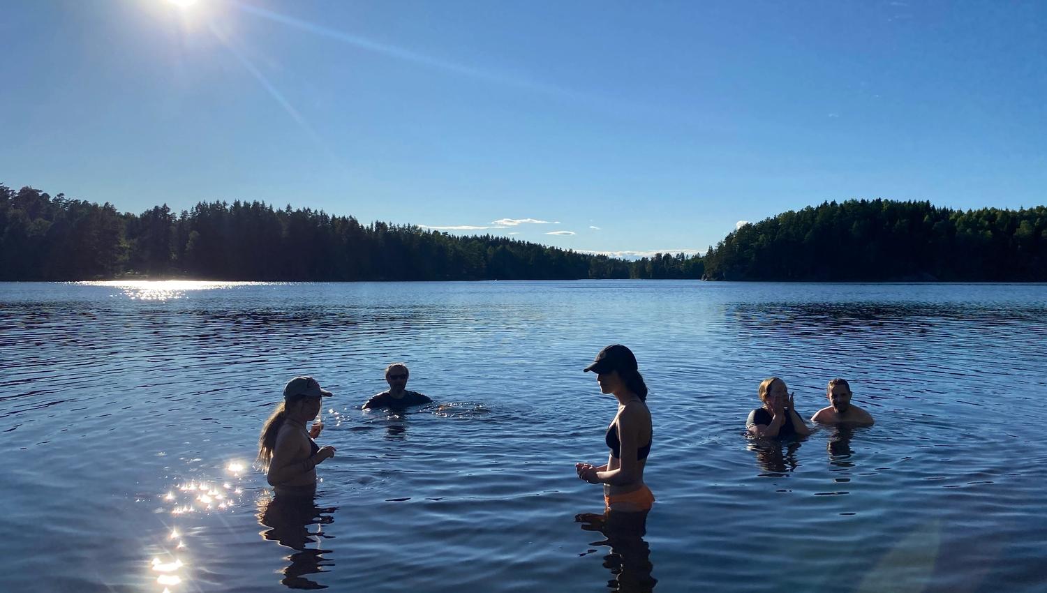 people swimming in a lake a summerday