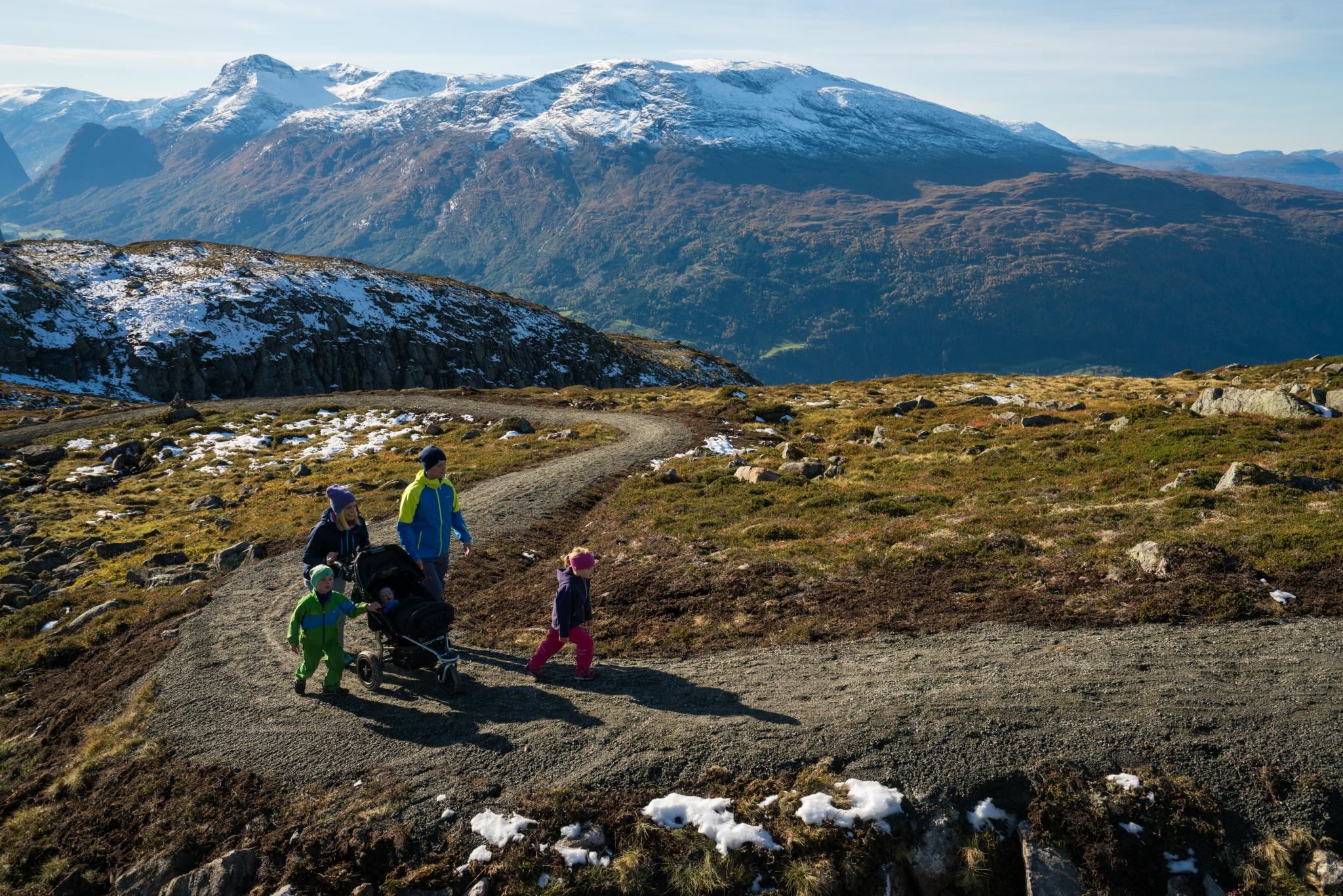 Group of hikers enjoying the mountain landscape and panoramic views from Hoven above Loen.