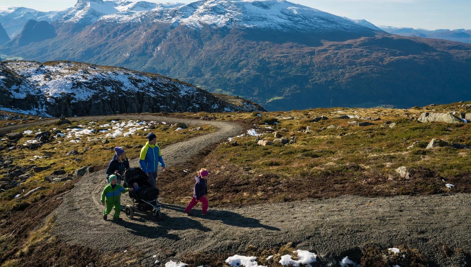 Group of hikers enjoying the mountain landscape and panoramic views from Hoven above Loen.