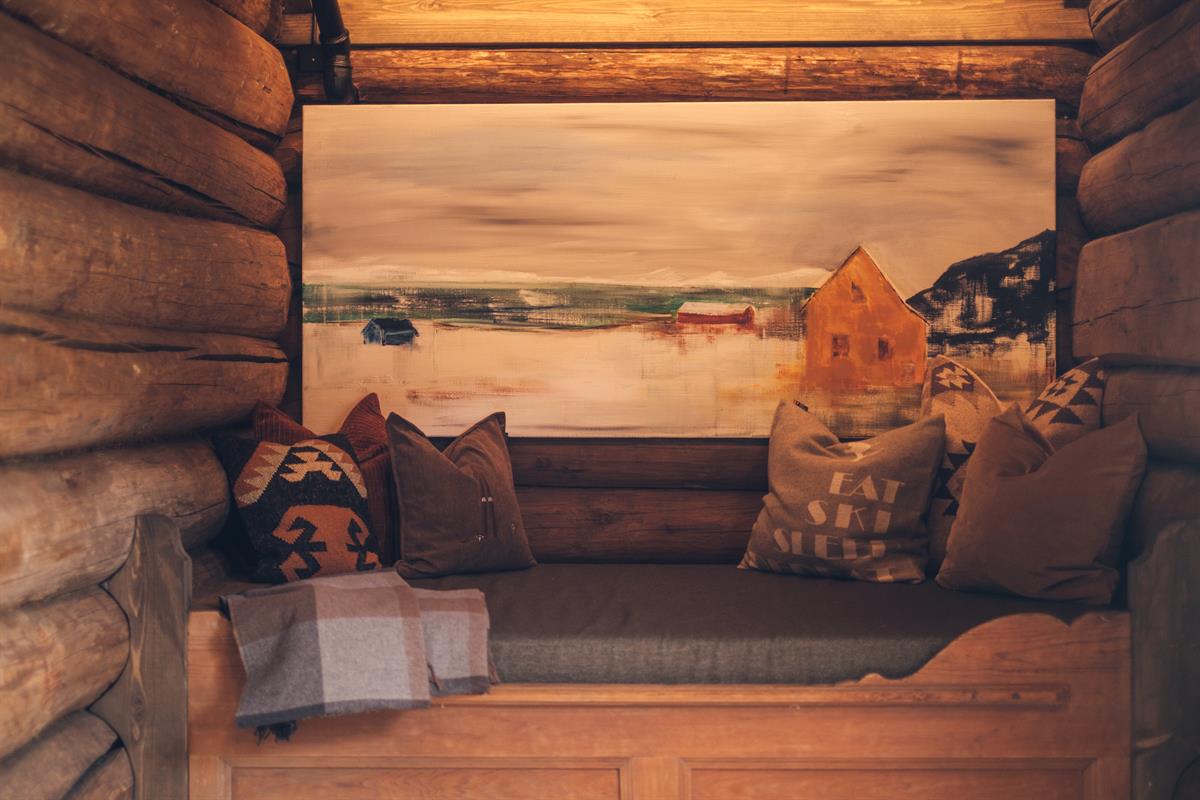 Cozy seating area with log walls and rustic interior.