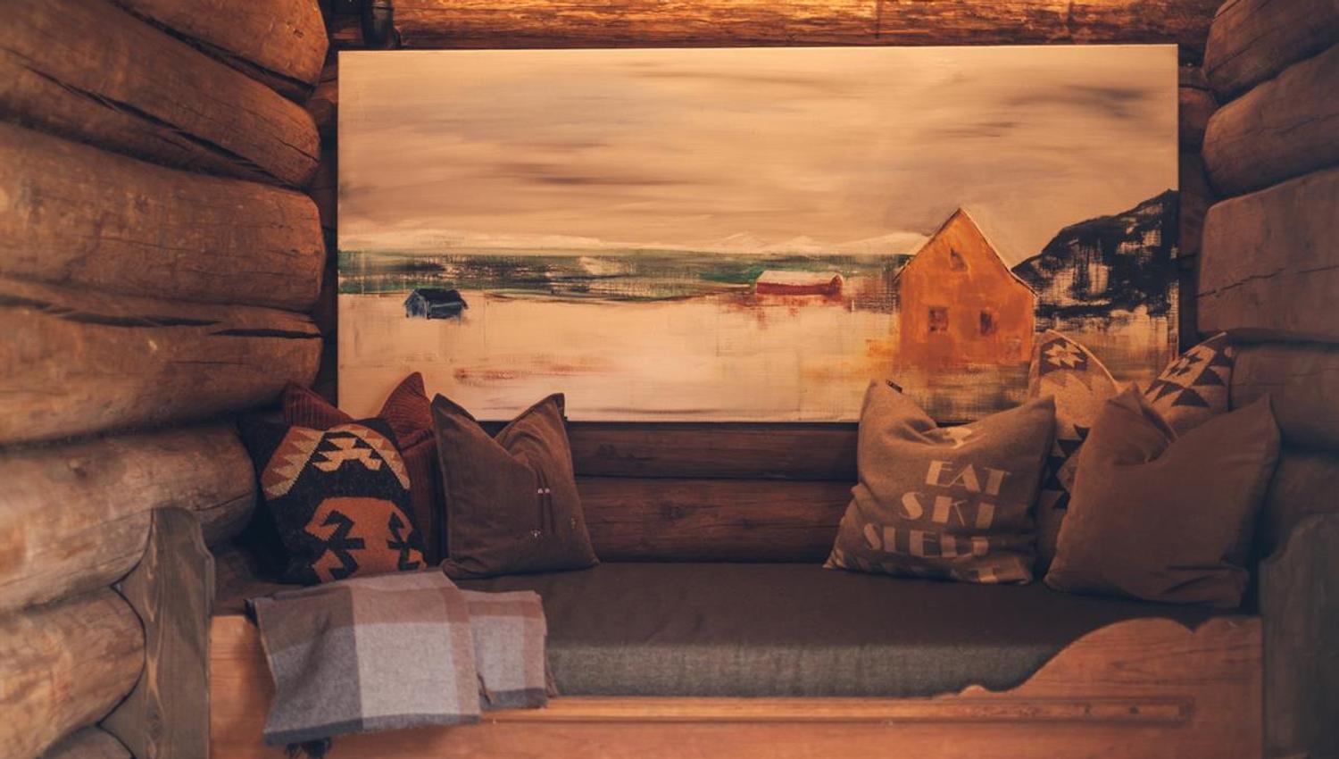 Cozy seating area with log walls and rustic interior.