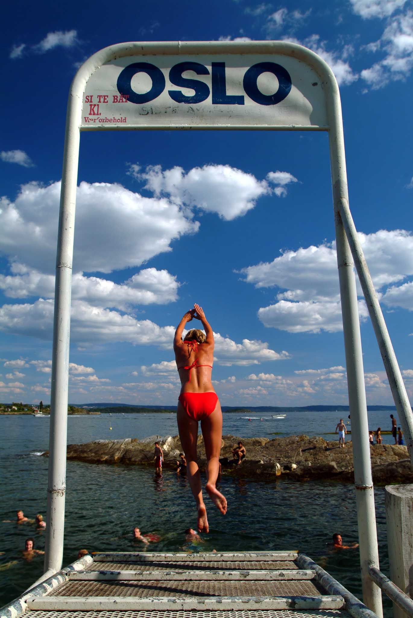 Girl jumping from a pier