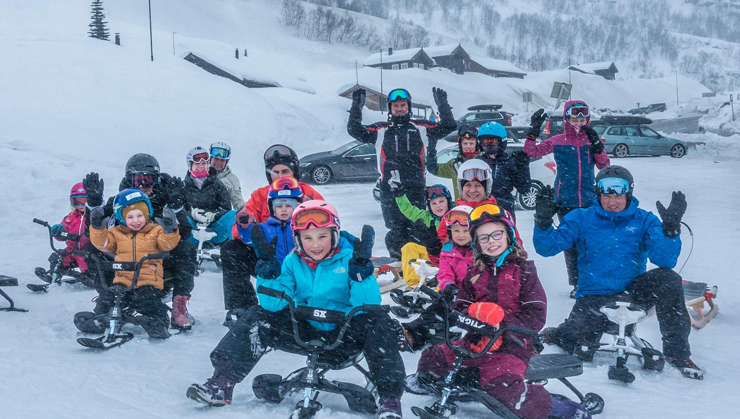 A group of happy kids on sleds.