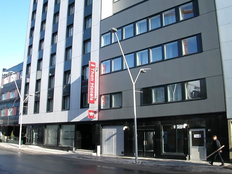 Multi-storey building with a "Thon Hotels" sign and large windows.