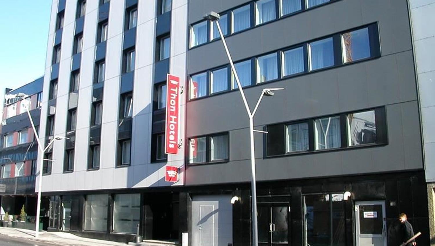 Multi-storey building with a "Thon Hotels" sign and large windows.