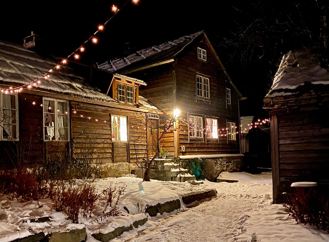 A building dressed in snow and Christmas lights 