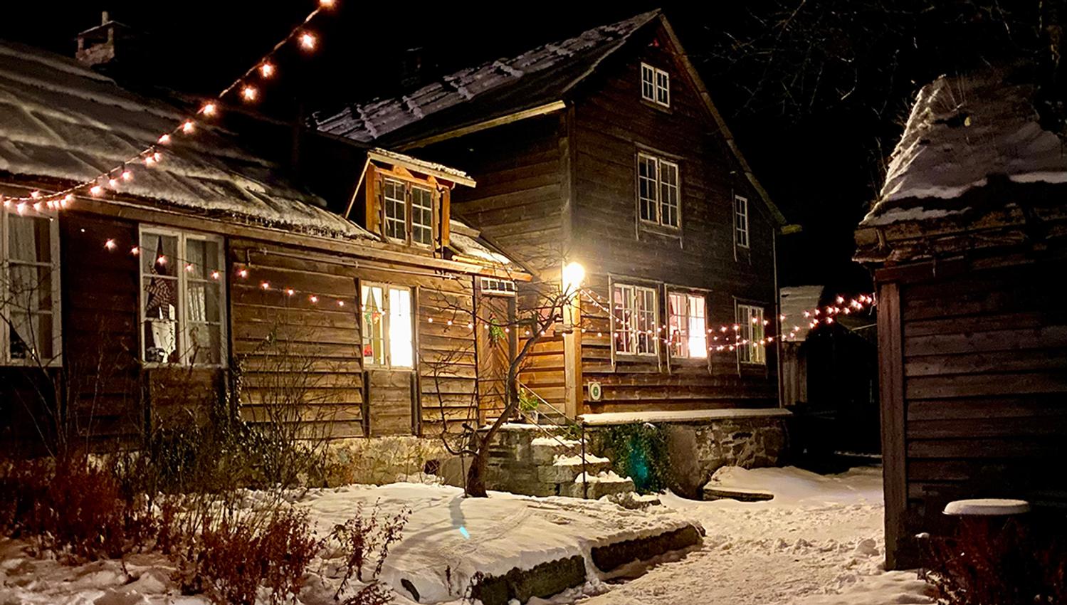A building dressed in snow and Christmas lights