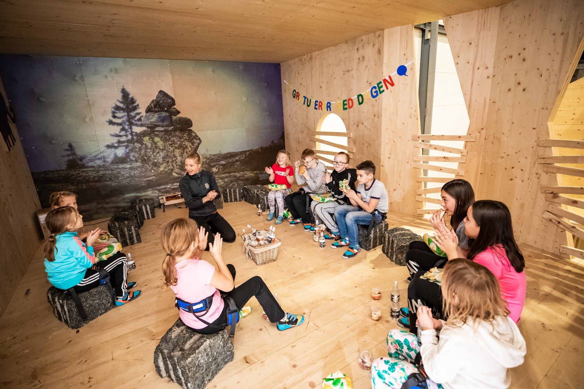 Children sit in a room and celebrate a birthday