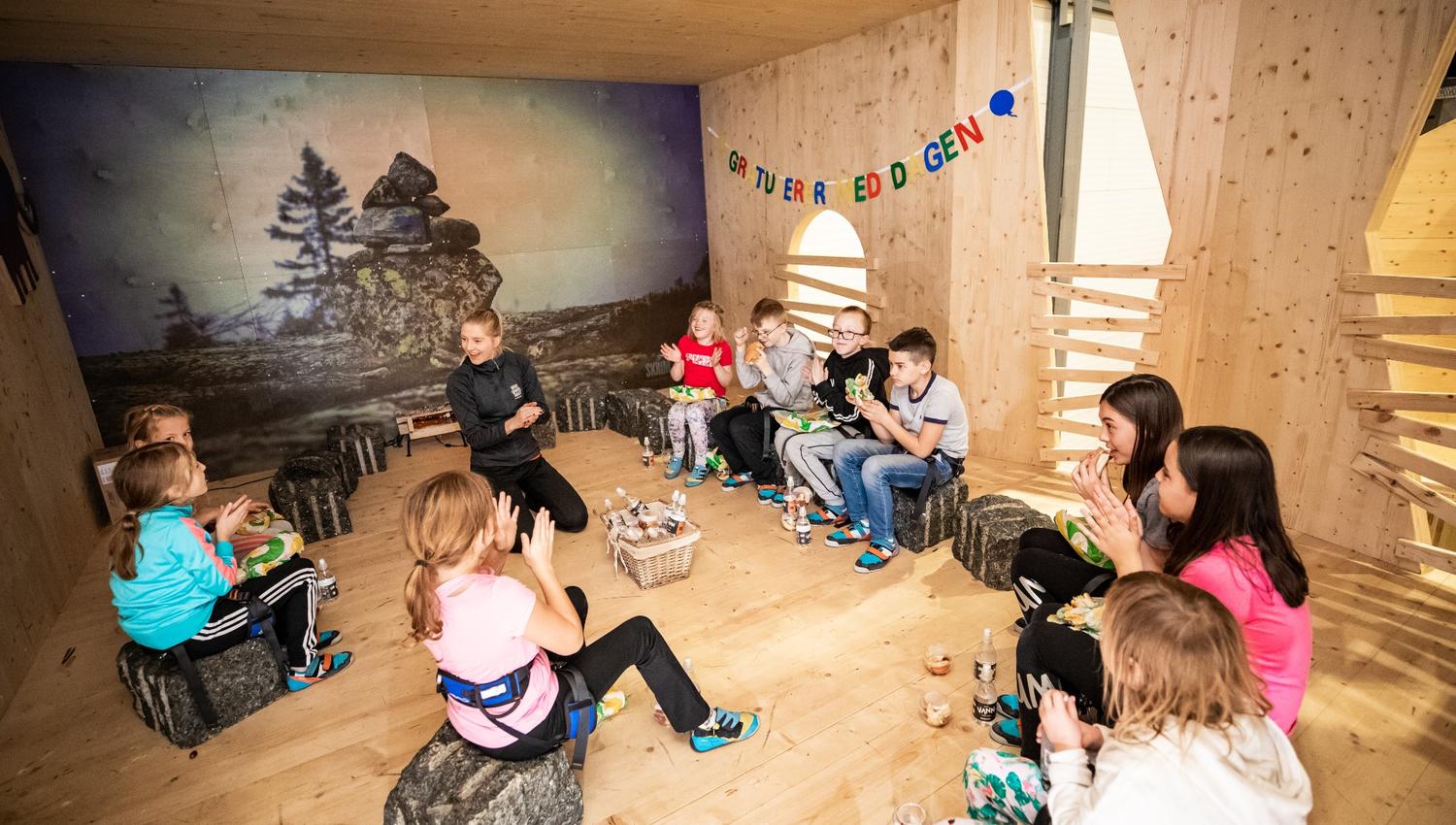 Children sit in a room and celebrate a birthday
