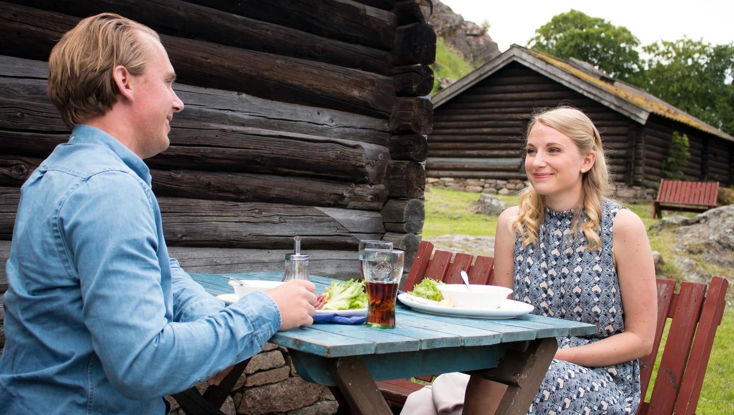 Two people eating outside at the seat cafe