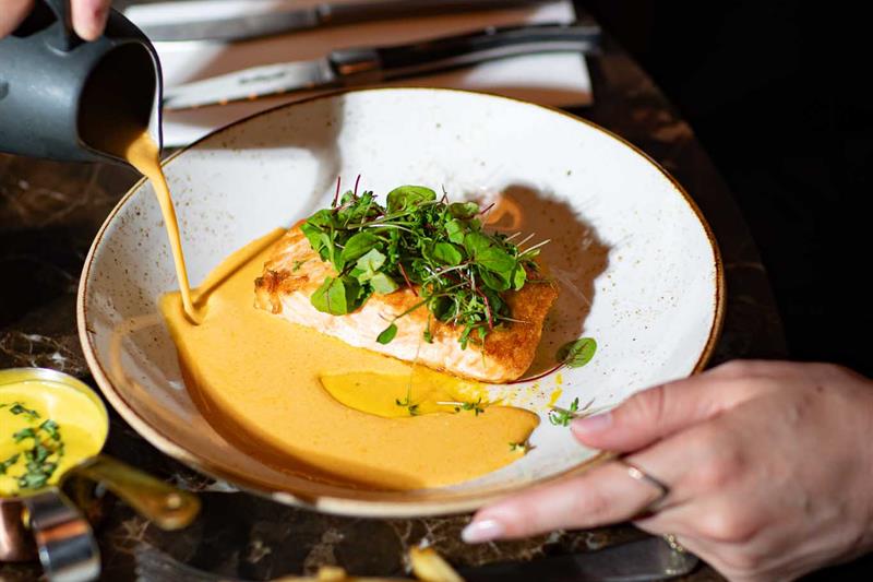 Detail of sauce being applied to steak