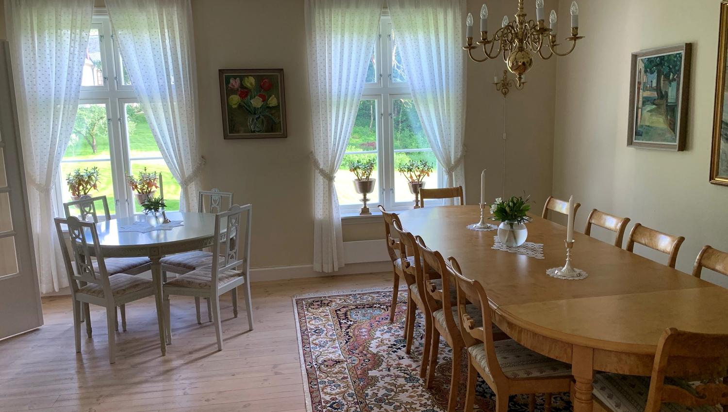 Et rom med et langbord og et vanlig bord.