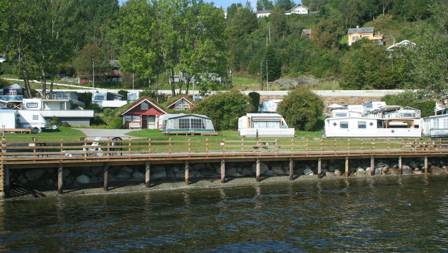 Caravan and cabin area along the waterfront at Hardanger Feriesenter.