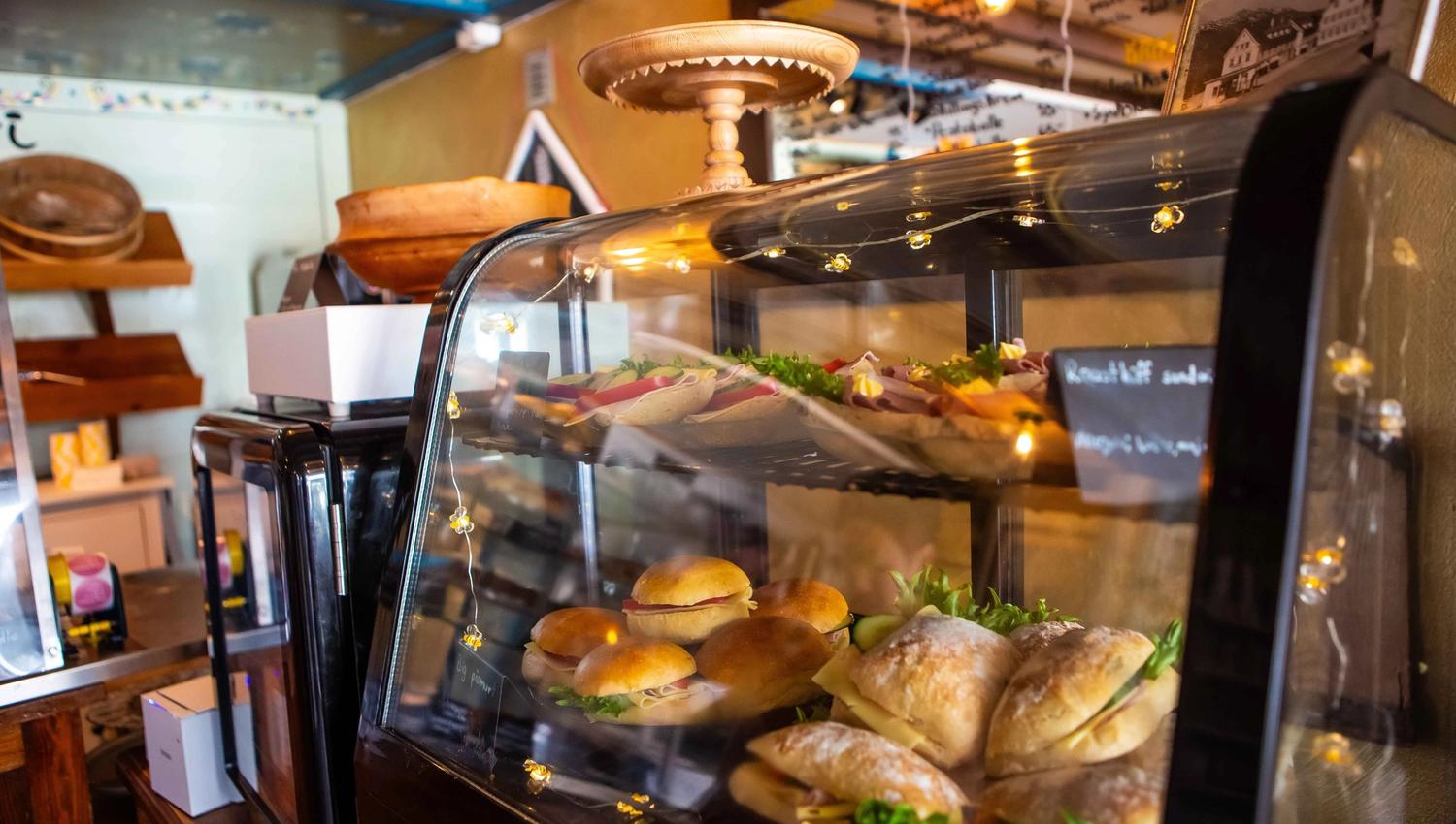 Fresh baked goods behind the counter at the charming Fløy Bakery in Lofthus.