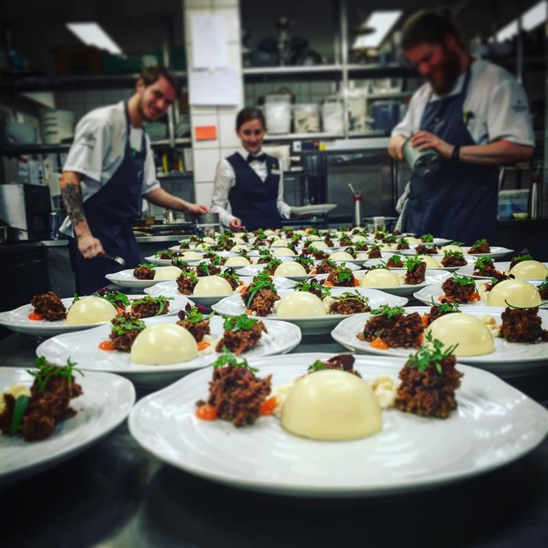 Kitchen staff preparing gourmet dishes. Photo
