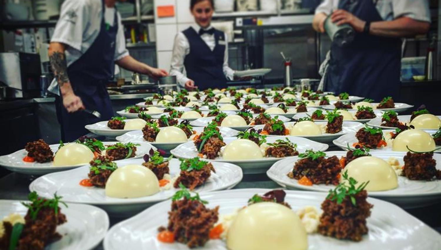 Kitchen staff preparing gourmet dishes. Photo