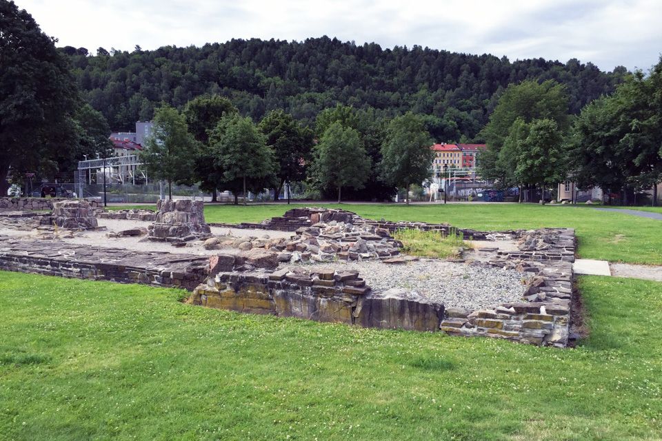 Stone ruins on a lawn.