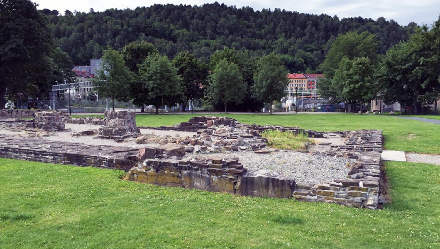 Stone ruins on a lawn.