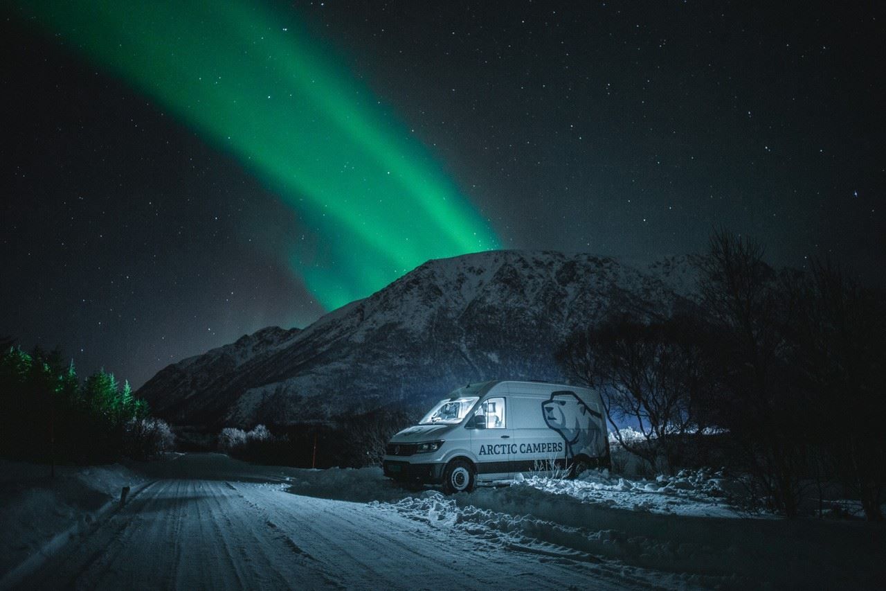 Camper van under the northern lights