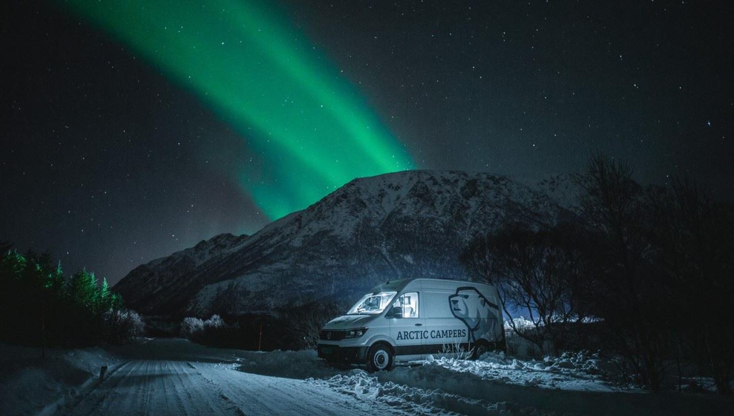 Camper van under the northern lights