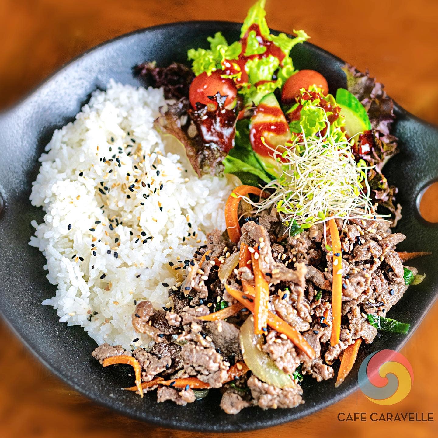 Plate with white rice, meat dish and salad