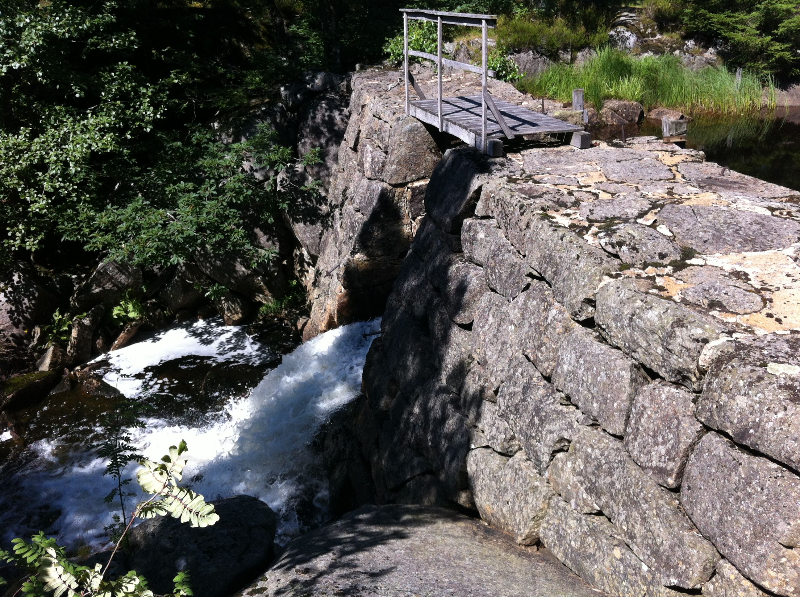 A dam with water flowing out on one side