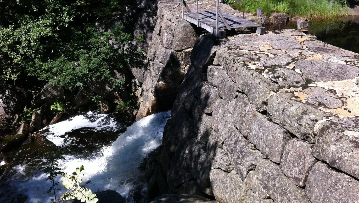 A dam with water flowing out on one side