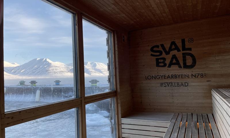 The view towards mountainous landscapes and a fjord from the interior of the sauna